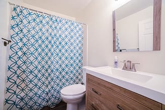 A bathroom with a shower curtain