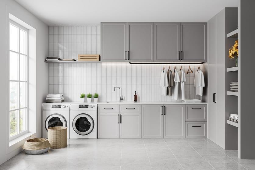 Stylish grey home laundry interior with sink