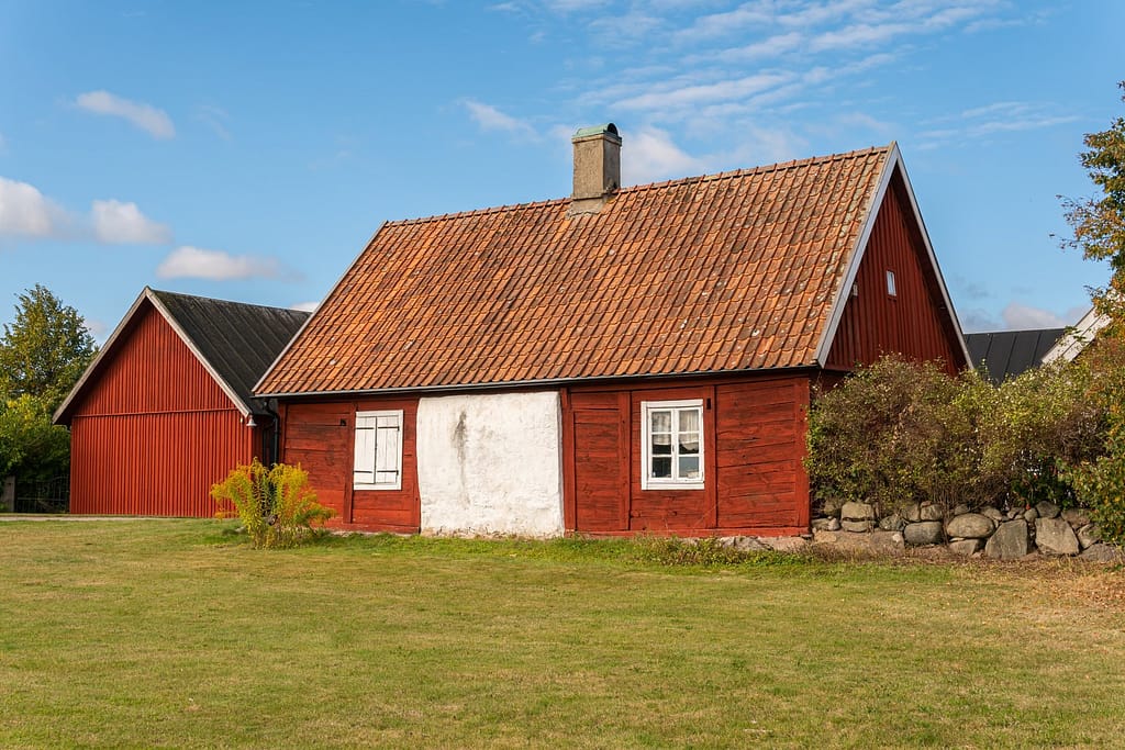 Rustic red exterior wooden house in vintage Scandinavian style