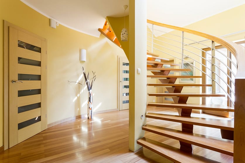 Spiral wooden staircase and doors in modern spacious interior